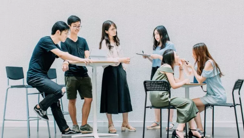 Group of interns collaborating at a table, representing BCA’s Summer Internship Program.